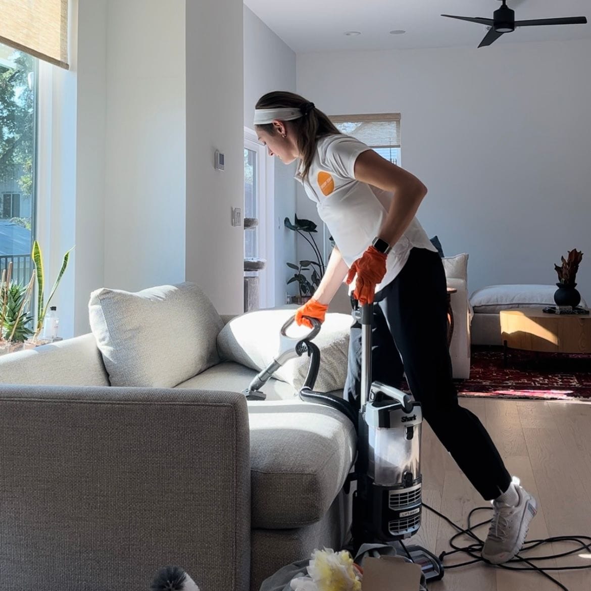 A woman cleaning a sofa